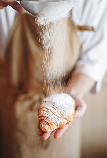 Baker making croissants